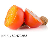 Ripe persimmons and nuts on white background. Стоковое фото, агентство Ingram Publishing / Фотобанк Лори