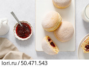 Berliner donut. Traditional german donut with raspberry jam, dusted with icing sugar. Top view. Стоковое фото, агентство Ingram Publishing / Фотобанк Лори