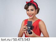 Happy fashion woman photographer hands holding retro vintage camera. Стоковое фото, агентство Ingram Publishing / Фотобанк Лори