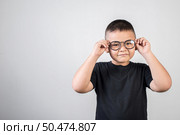 Funny boy genius wearing glasses in studio shot. Стоковое фото, агентство Ingram Publishing / Фотобанк Лори