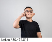 Funny Genius boy Thinking in studio shot. Стоковое фото, агентство Ingram Publishing / Фотобанк Лори