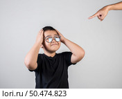 Boy feels sad after the parents scold him. Стоковое фото, агентство Ingram Publishing / Фотобанк Лори