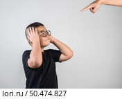 Boy feels sad after the parents scold him. Стоковое фото, агентство Ingram Publishing / Фотобанк Лори