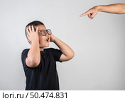 Boy feels sad after the parents scold him. Стоковое фото, агентство Ingram Publishing / Фотобанк Лори