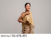Women wearing Thai clothes and right hand grasping her shoulders. Стоковое фото, агентство Ingram Publishing / Фотобанк Лори