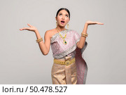 women wear Thai clothes and open their hands on both sides. Стоковое фото, агентство Ingram Publishing / Фотобанк Лори