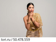 women is wearing Thai clothes and hand-made to cover her mouth. Стоковое фото, агентство Ingram Publishing / Фотобанк Лори