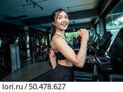 Women jogging on the treadmill in the gym. Стоковое фото, агентство Ingram Publishing / Фотобанк Лори