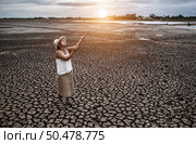 The woman stand looking at the sky and asked for rain in the dry weather,global warming. Стоковое фото, агентство Ingram Publishing / Фотобанк Лори