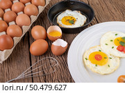 Fried eggs in a frying pan and raw eggs, organic food for good health, high in protein. Стоковое фото, агентство Ingram Publishing / Фотобанк Лори