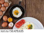 Fried eggs in a frying pan and raw eggs, organic food for good health, high in protein. Стоковое фото, агентство Ingram Publishing / Фотобанк Лори