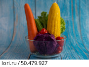 Tomatoes, carrots, cucumbers, onions, salads, onions and purple cabbage in a glass cup.Selective focus. Стоковое фото, агентство Ingram Publishing / Фотобанк Лори
