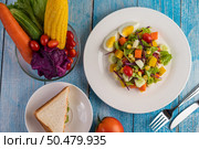 The salad is on a white plate, with a sandwich and tomatoes on the blue wooden floor. Стоковое фото, агентство Ingram Publishing / Фотобанк Лори