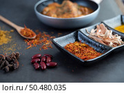 Massaman curry in a frying pan with spices on the cement floor. Selective focus. Стоковое фото, агентство Ingram Publishing / Фотобанк Лори