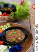 Chili paste paste in a bowl with eggplant, carrots, chili, cucumbers in a basket on wood table. Стоковое фото, агентство Ingram Publishing / Фотобанк Лори
