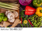 Chilli, lime, basil, kaffir lime leaves, eggplant, ginger, spring onions, bell peppers, garlic, lemongrass, put together for cooking. Стоковое фото, агентство Ingram Publishing / Фотобанк Лори