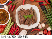 Grilled pork liver in a white plate with tomato, garlic, yard long bean, and sauce. Стоковое фото, агентство Ingram Publishing / Фотобанк Лори