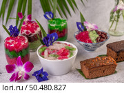 Desserts in cups placed on cement floor, Thai desserts. Стоковое фото, агентство Ingram Publishing / Фотобанк Лори