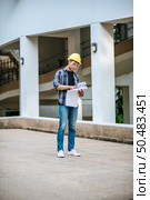 Architects hold the building plan and check the work. Стоковое фото, агентство Ingram Publishing / Фотобанк Лори