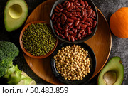 legumes and fruit on a black cement floor background. Стоковое фото, агентство Ingram Publishing / Фотобанк Лори