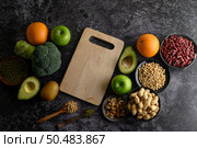 legumes and fruit on a black cement floor background. Стоковое фото, агентство Ingram Publishing / Фотобанк Лори
