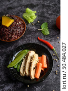 Purple rice berries cooked with grilled chicken breast. Pumpkin, carrots, and mint leaves in a dish, clean food. Selective focus. Стоковое фото, агентство Ingram Publishing / Фотобанк Лори