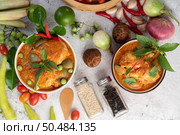 Chicken red curry in a black bowl, chilli, tomato, galangal, shiitake mushroom and eggplant. Стоковое фото, агентство Ingram Publishing / Фотобанк Лори