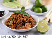 Spicy pork chops in a white dish consisting of lemons, chilies, and side dishes. Selective focus. Стоковое фото, агентство Ingram Publishing / Фотобанк Лори