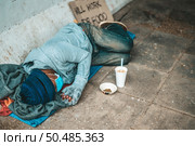 The beggars lay on their side of the street with dirty clothes. Стоковое фото, агентство Ingram Publishing / Фотобанк Лори