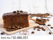Chocolate cake on the sack with coffee beans on a wooden table. Selective focus. Стоковое фото, агентство Ingram Publishing / Фотобанк Лори
