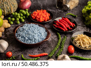 Butterfly Pea flower rice in a brown cup with spices on black cement. Стоковое фото, агентство Ingram Publishing / Фотобанк Лори