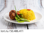 Chicken Biryani in a plate on a white wooden floor. Стоковое фото, агентство Ingram Publishing / Фотобанк Лори