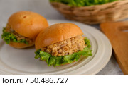Selective focus Appetizing with two chicken hamburgers and lettuce placed in white dish beautifully, copy space. Стоковое фото, агентство Ingram Publishing / Фотобанк Лори