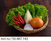 Vegetable and Ingredient herb for cooking salad in wicker basket on wooden table, copy space for insert text. Стоковое фото, агентство Ingram Publishing / Фотобанк Лори