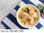 Tom Kha Kai in a bowl with kaffir lime leaves, lemongrass, red onion, galangal and chilli.Selective focus. Стоковое фото, агентство Ingram Publishing / Фотобанк Лори