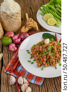 Spicy minced pork on a white plate and sticky rice box. Стоковое фото, агентство Ingram Publishing / Фотобанк Лори