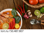 Tom Yum Kung Thai hot spicy soup shrimp with lemon grass,lemon,galangal and chilli on wooden background Thailand Food. Стоковое фото, агентство Ingram Publishing / Фотобанк Лори