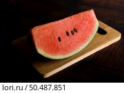 Cut watermelon in chopping boards on a wooden table. Стоковое фото, агентство Ingram Publishing / Фотобанк Лори