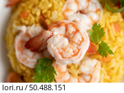 Shrimp fried rice with tomatoes Carrots and scallions on the plate. Стоковое фото, агентство Ingram Publishing / Фотобанк Лори