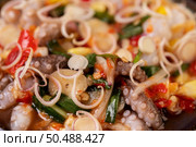 Squid salad with coriander, chopped green onion, garlic and corn on the plate. Стоковое фото, агентство Ingram Publishing / Фотобанк Лори