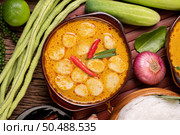 Red curry meatballs with chili and scallions in a bowl. Стоковое фото, агентство Ingram Publishing / Фотобанк Лори