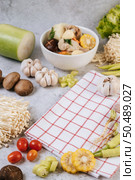 Ingredients used to make soup include corn, shiitake mushrooms, tomatoes, needle mushrooms, chili, and garlic. Стоковое фото, агентство Ingram Publishing / Фотобанк Лори