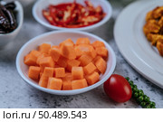 Carrots are diced in a cup with tomatoes and fresh pepper seeds. Стоковое фото, агентство Ingram Publishing / Фотобанк Лори
