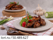 Sweet pork in a white plate with chopped scallions, chili, lime, gourd, tomato and garlic. Стоковое фото, агентство Ingram Publishing / Фотобанк Лори