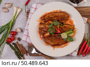 Sweet pork in a white plate with chili, spring onions, carrots, and coriander. Стоковое фото, агентство Ingram Publishing / Фотобанк Лори