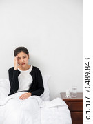 The sick woman had a headache and the hands touched her head on the bed. Стоковое фото, агентство Ingram Publishing / Фотобанк Лори