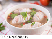 Squid soup stuffed with pork, sprinkled with coriander and chopped scallions in white cups. Стоковое фото, агентство Ingram Publishing / Фотобанк Лори