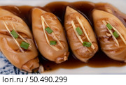 Squid stuffed with pork in black sauce in white plate. Стоковое фото, агентство Ingram Publishing / Фотобанк Лори