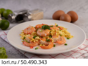 Stir fried eggs with shrimp on a white plate sprinkled with sliced ??spring onions. Стоковое фото, агентство Ingram Publishing / Фотобанк Лори