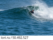 Bodyboarder surfing ocean wave on a sunny winter day. Стоковое фото, агентство Ingram Publishing / Фотобанк Лори